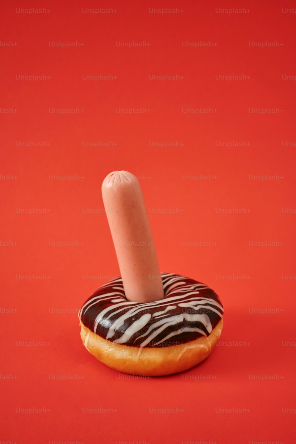 a donut with a single candle sticking out of it