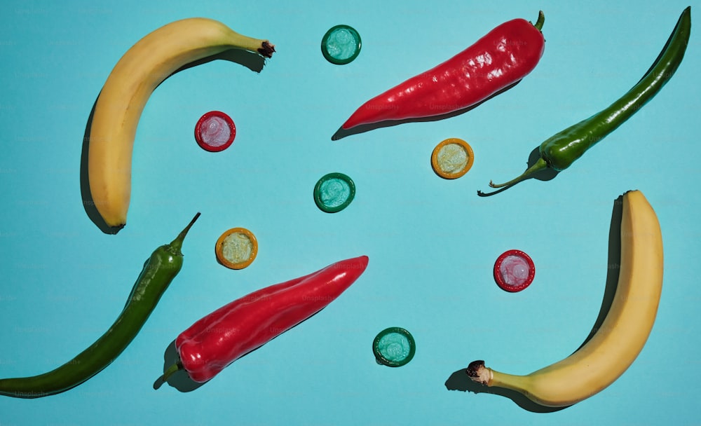 a group of peppers and a banana on a blue surface