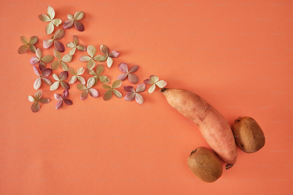 a banana and two pieces of fruit on an orange background