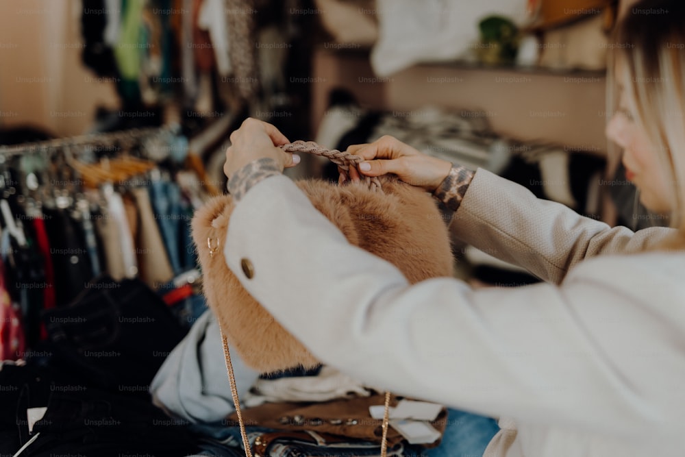 a woman in a white shirt is cutting a fur