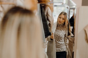 a woman standing in front of a mirror