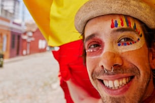a man with his face painted like a flag