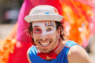 a man with face paint and a hat on
