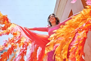 a woman in a pink and orange costume