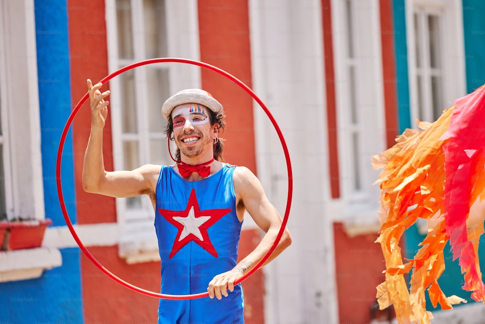 a man in a costume is holding a hoop