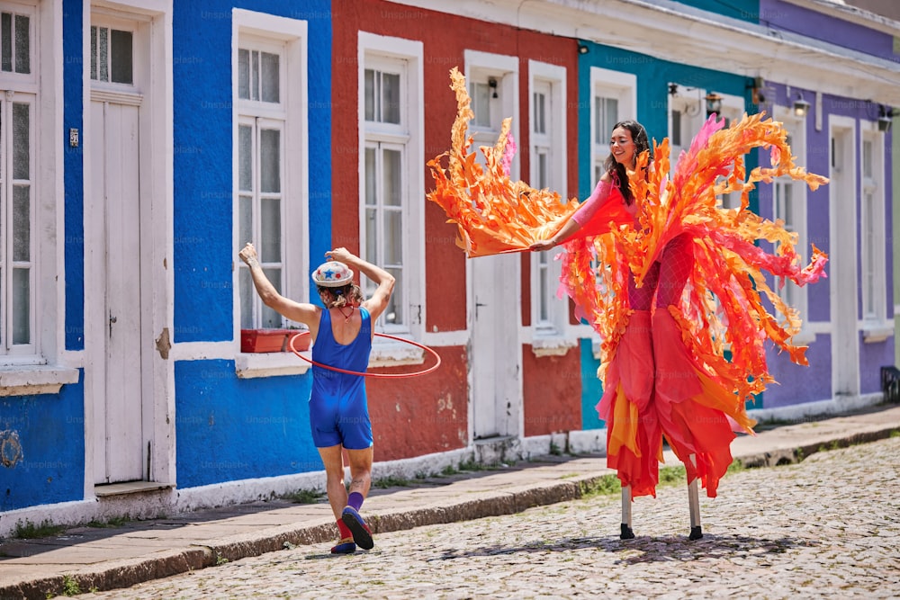 a woman in a blue dress and a woman in a red and orange dress