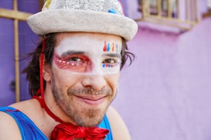 a man with his face painted like a clown