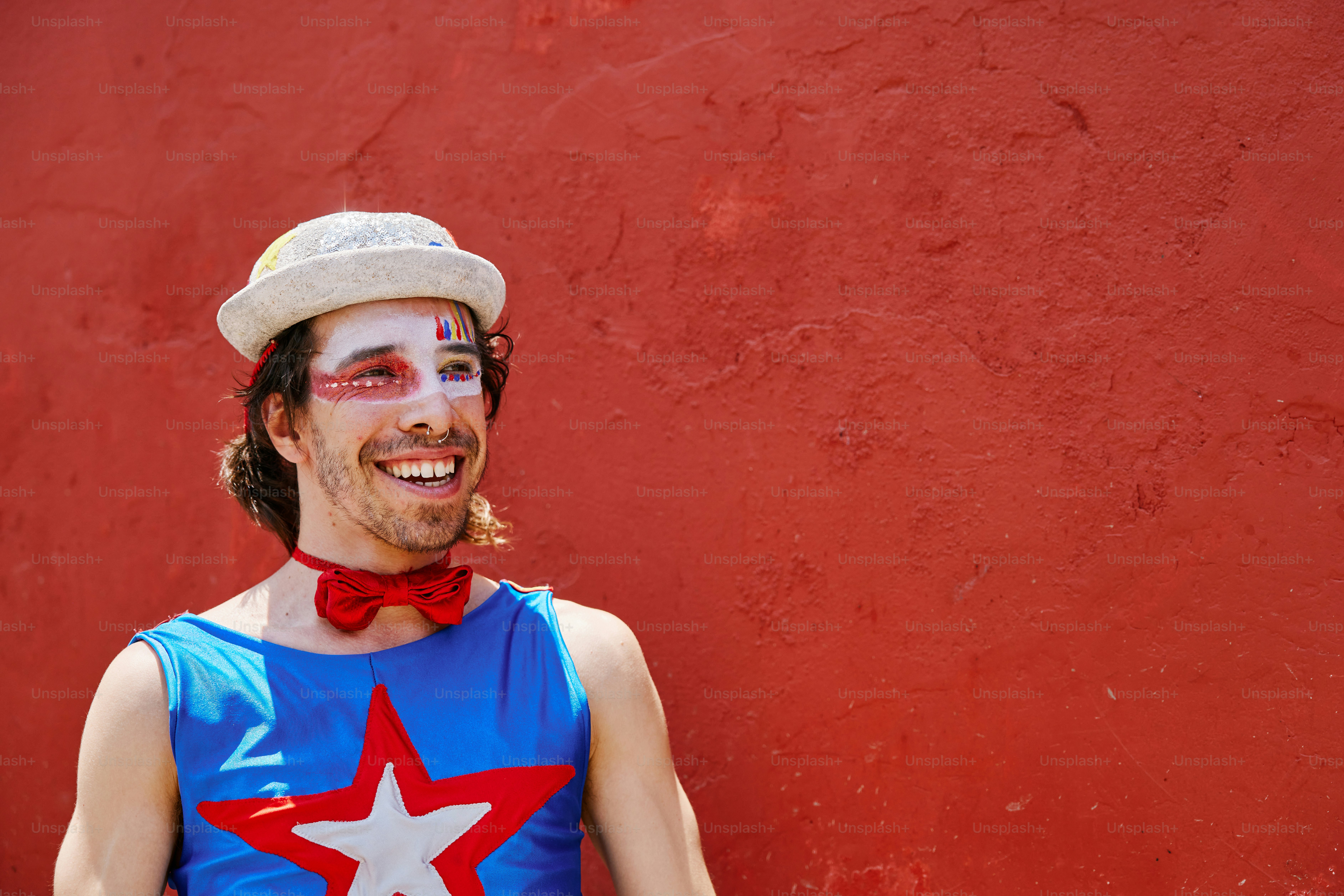 a man in a clown costume poses for a picture