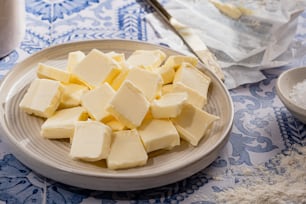 a plate of butter cubes on a table