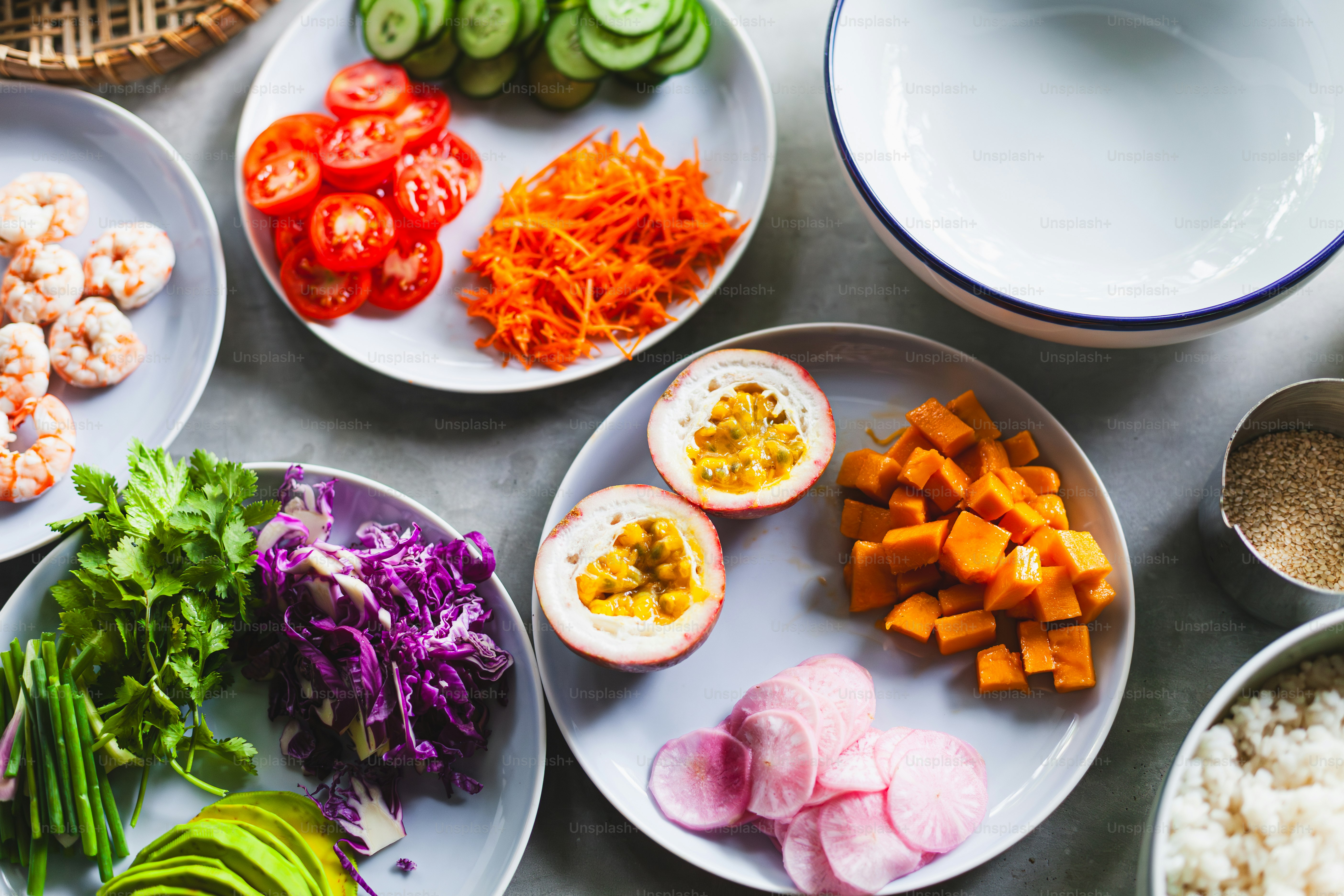 a table topped with plates of food and bowls of rice