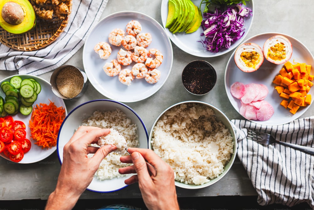 a person sitting at a table with bowls of food