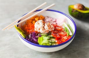 a bowl of food with chopsticks in it