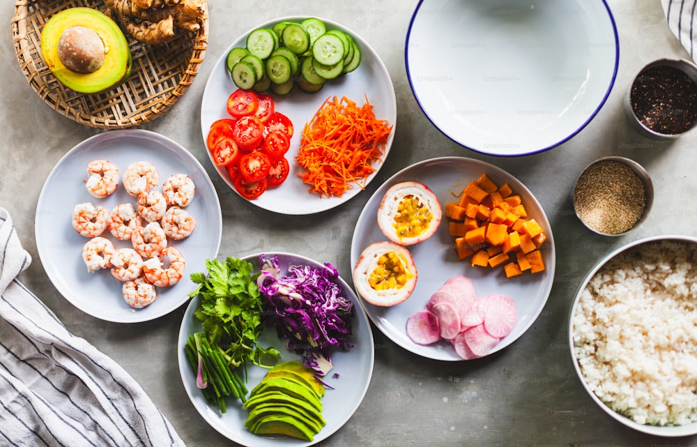 a table topped with plates of food and bowls of vegetables