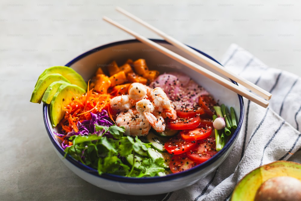 a bowl of food with chopsticks in it