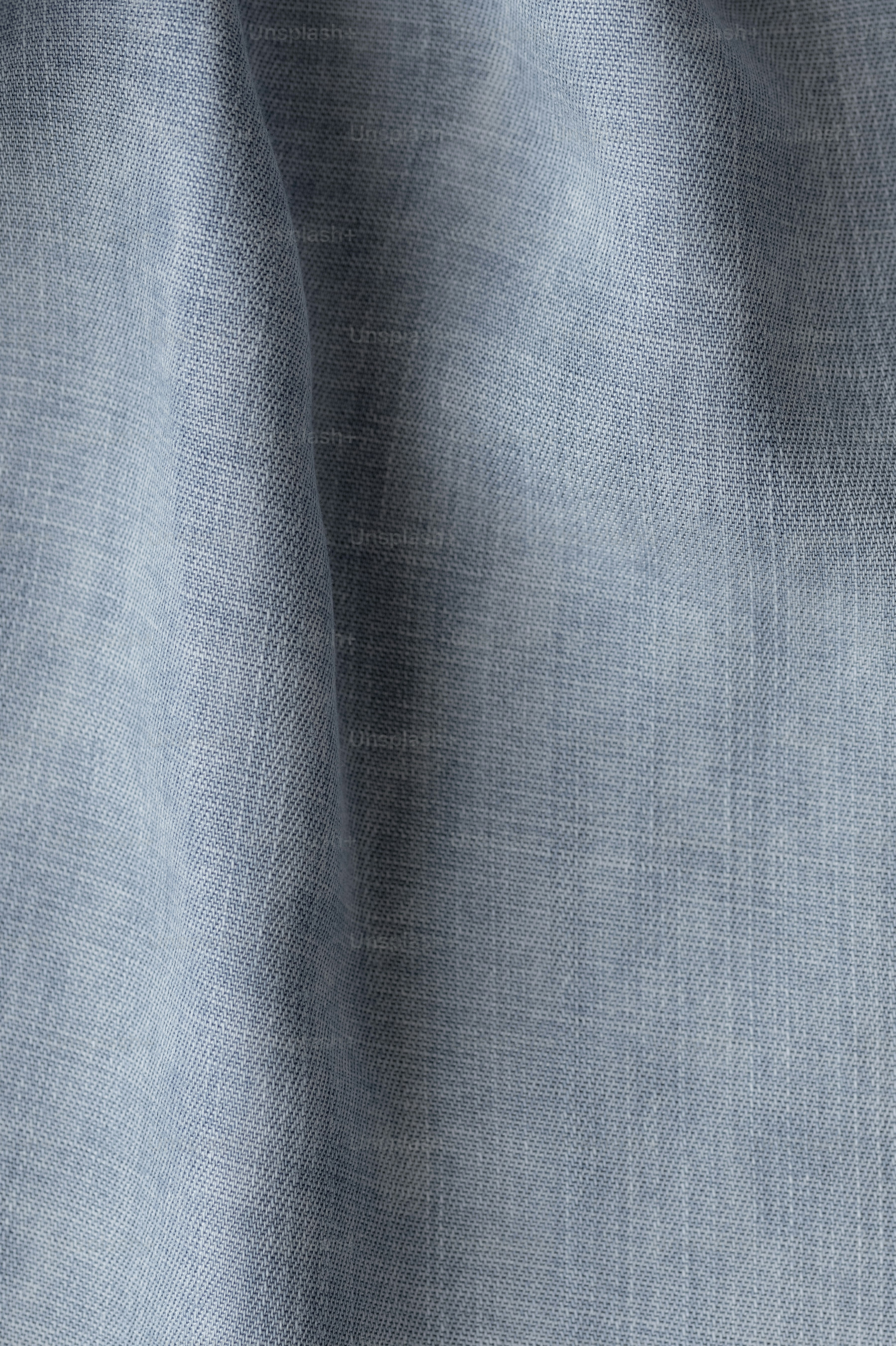 a close up view of a light blue fabric