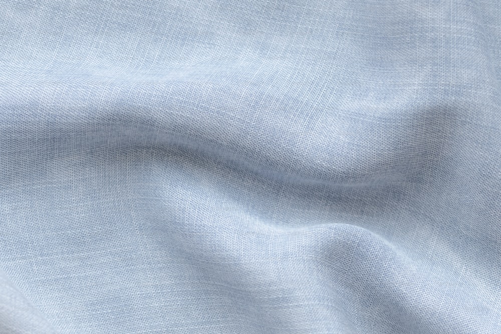 a close up view of a light blue fabric