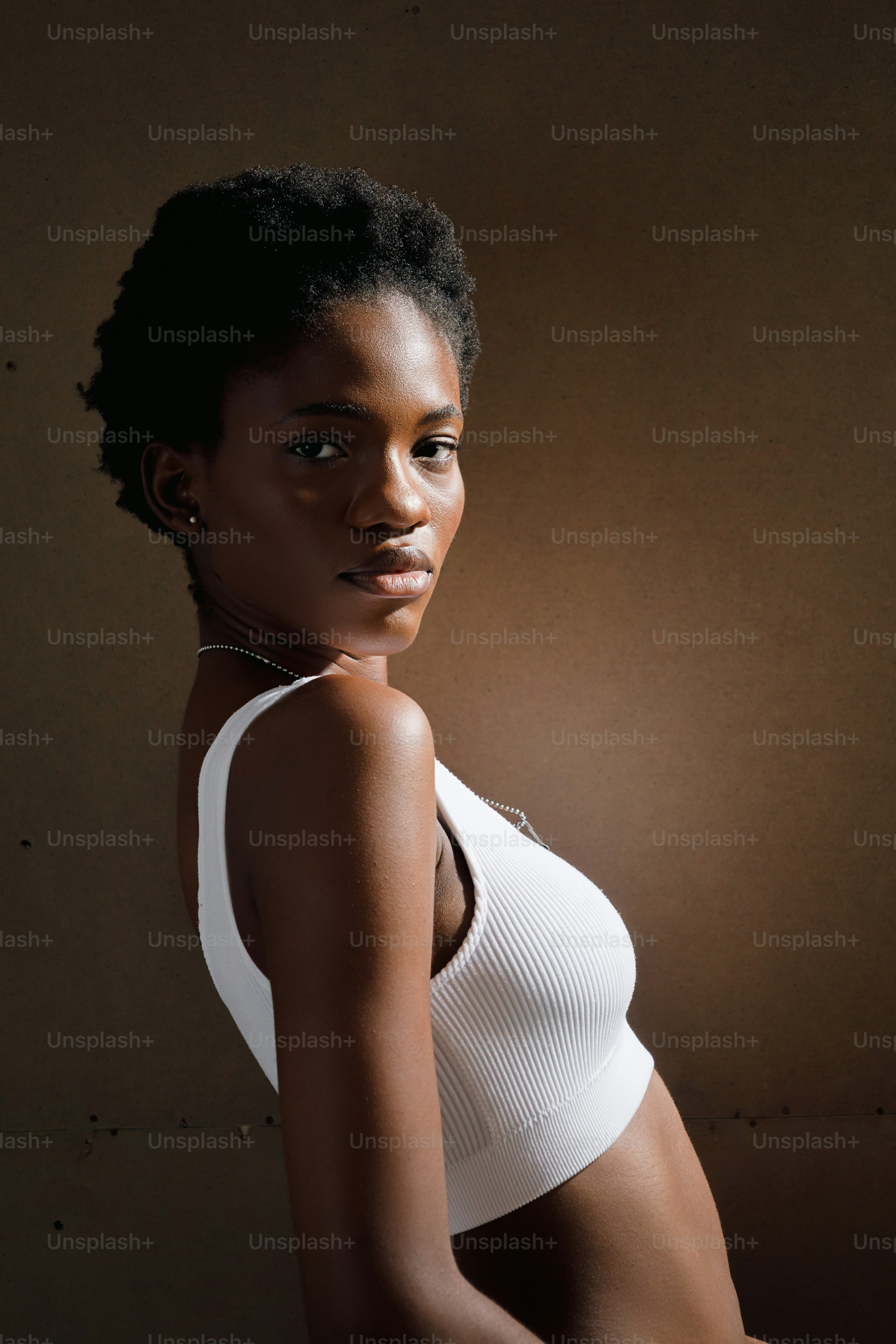 a woman in a white top posing for a picture