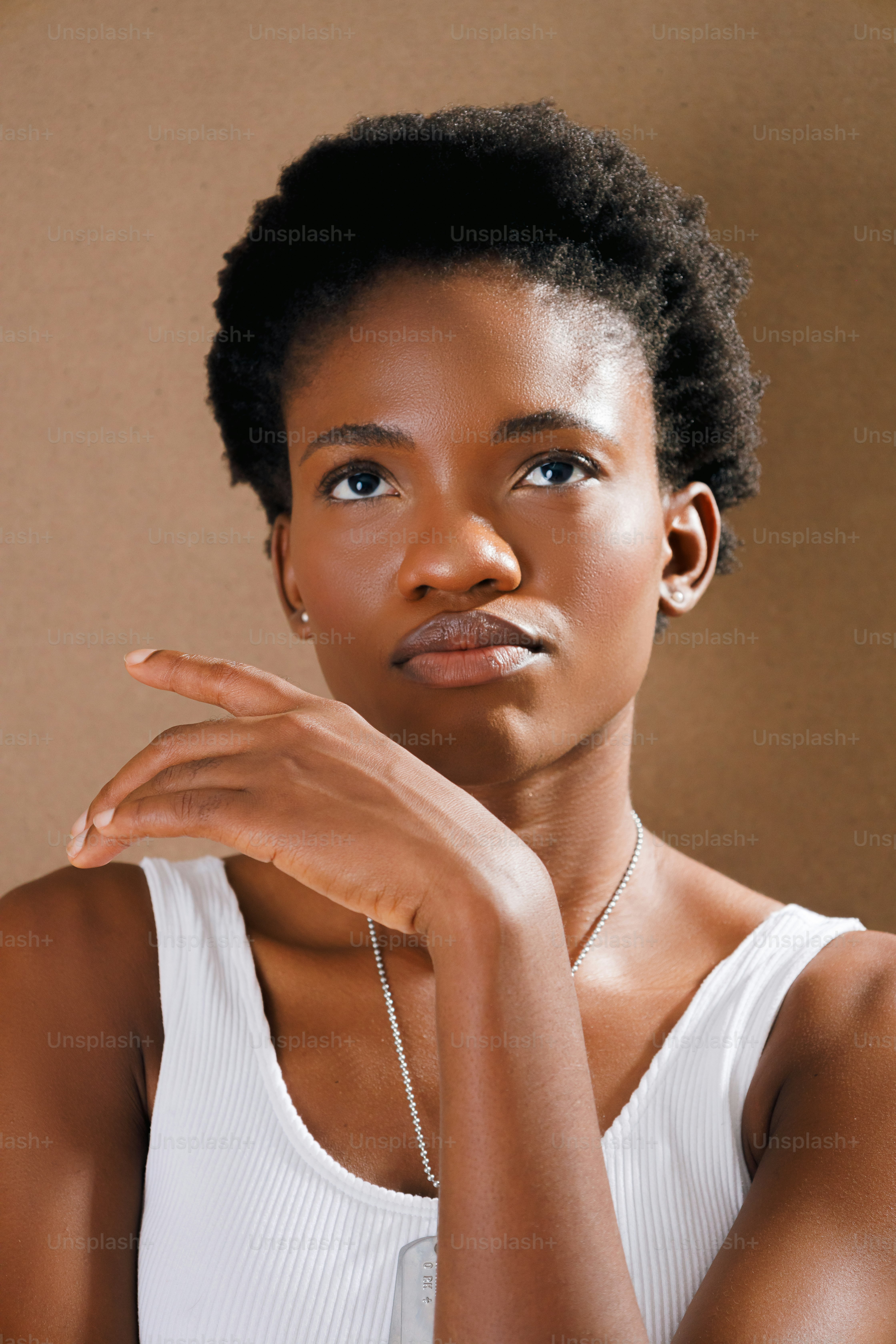 une femme dans un débardeur blanc posant pour une photo