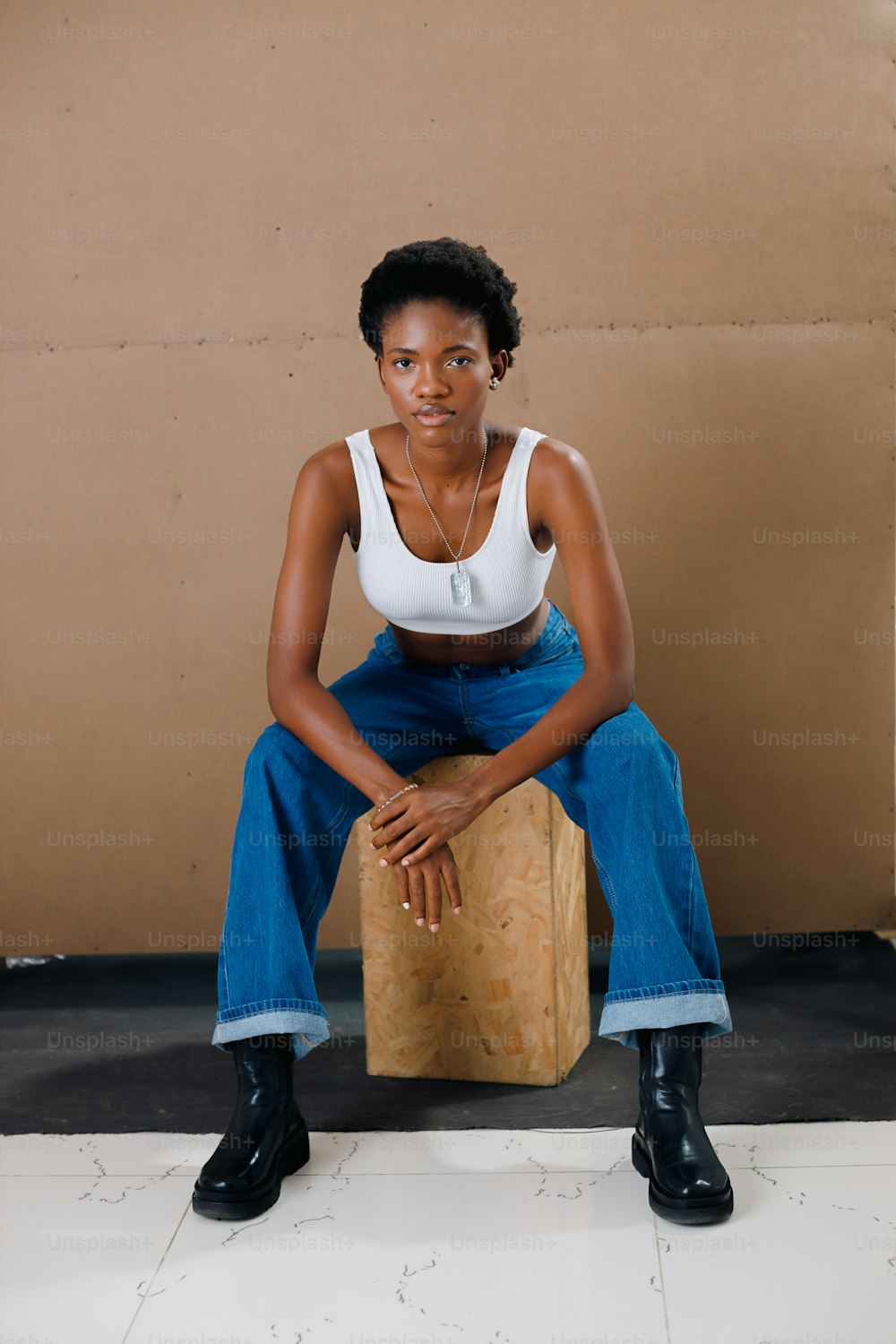 a woman sitting on top of a wooden block