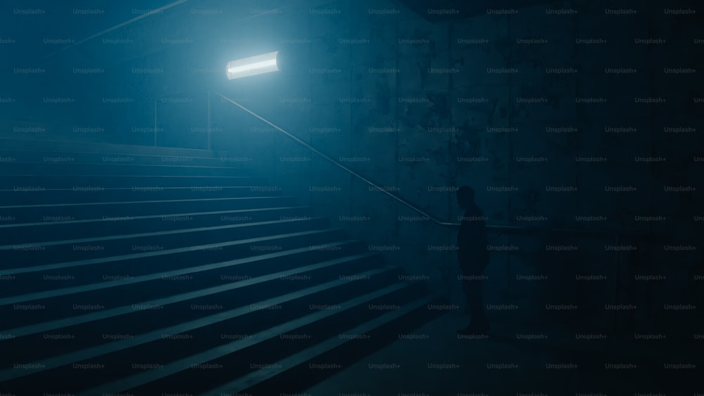 a person standing on a set of stairs in the dark