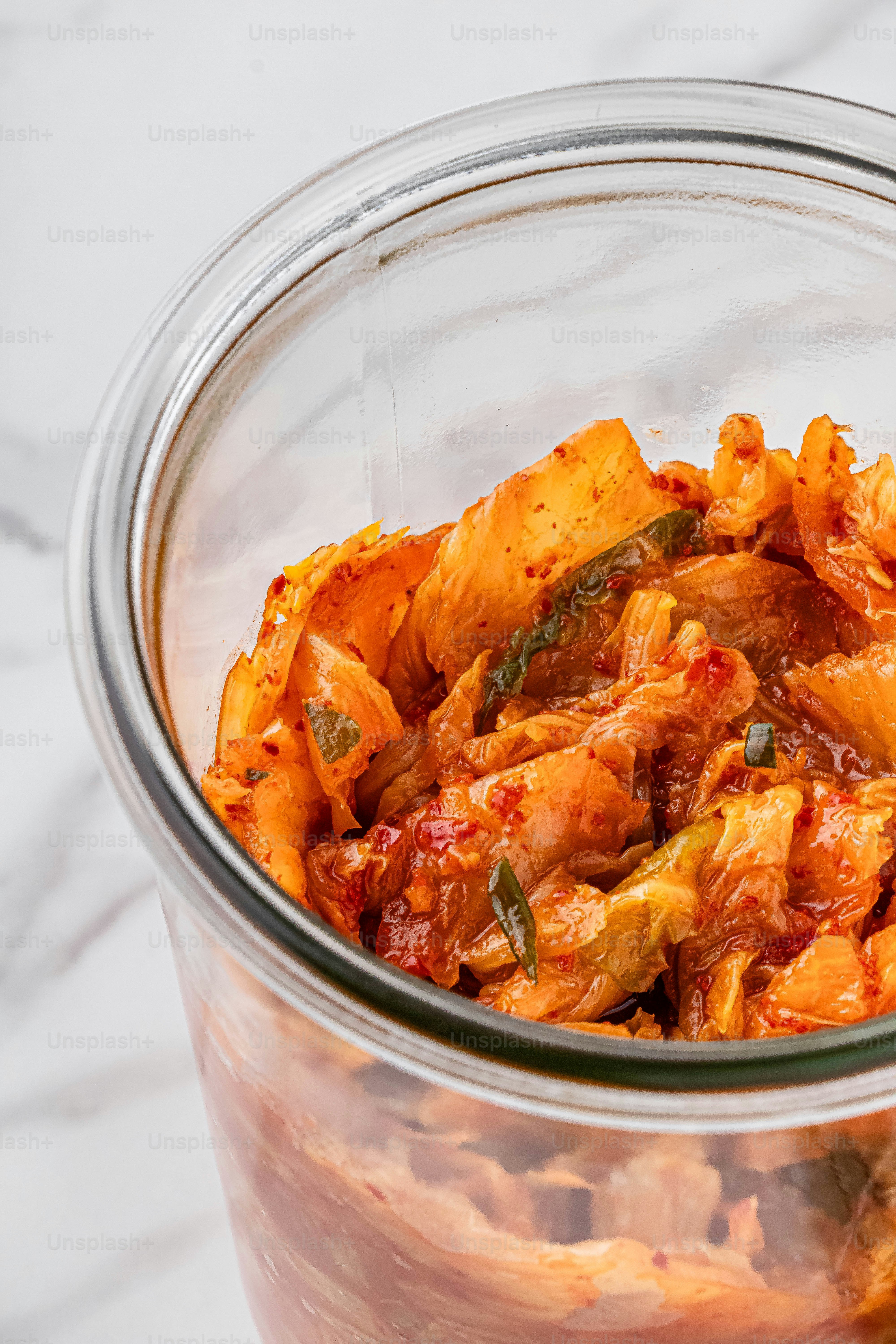 a glass jar filled with food on top of a table
