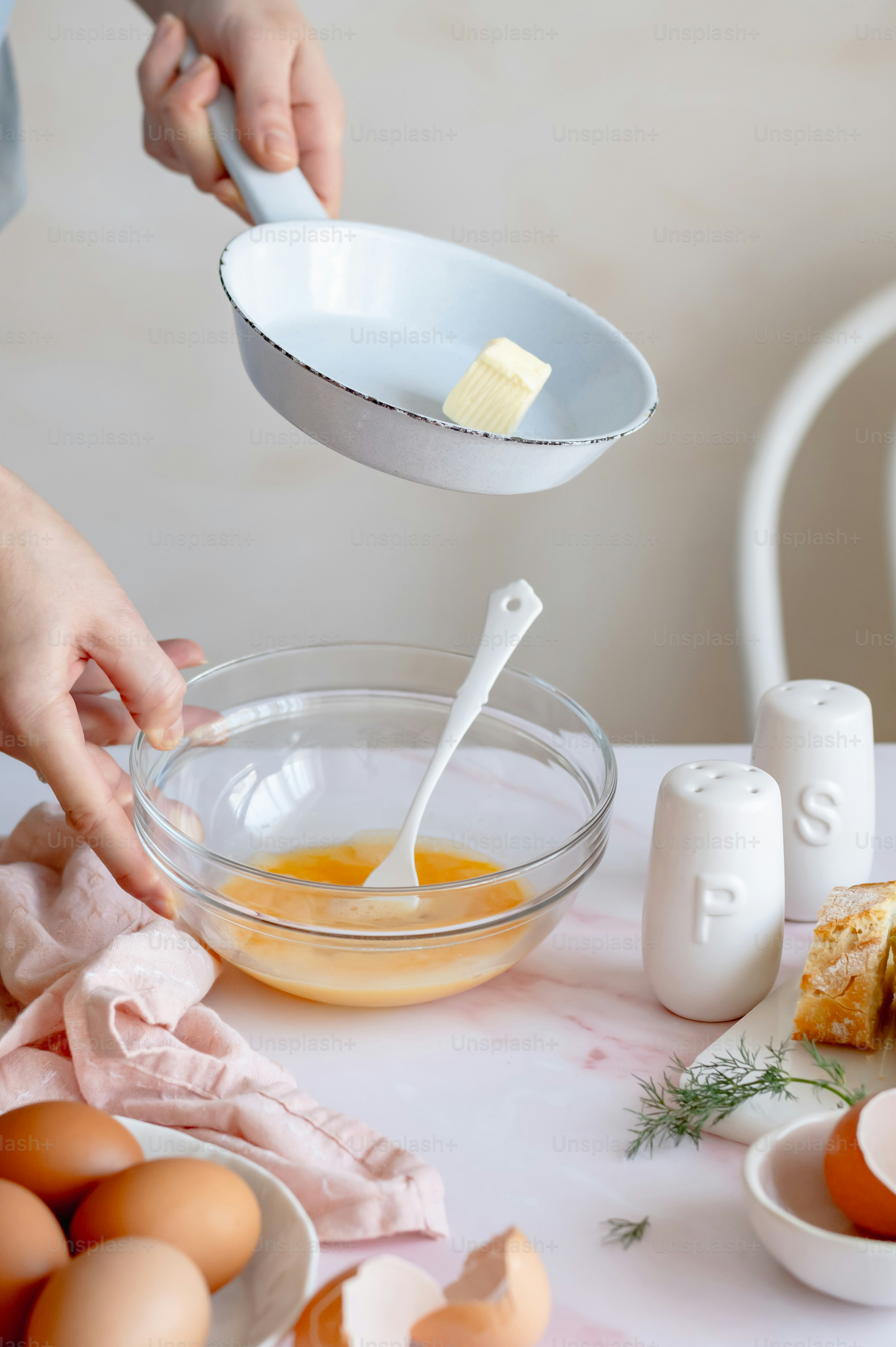 a person mixing eggs in a bowl with a spoon