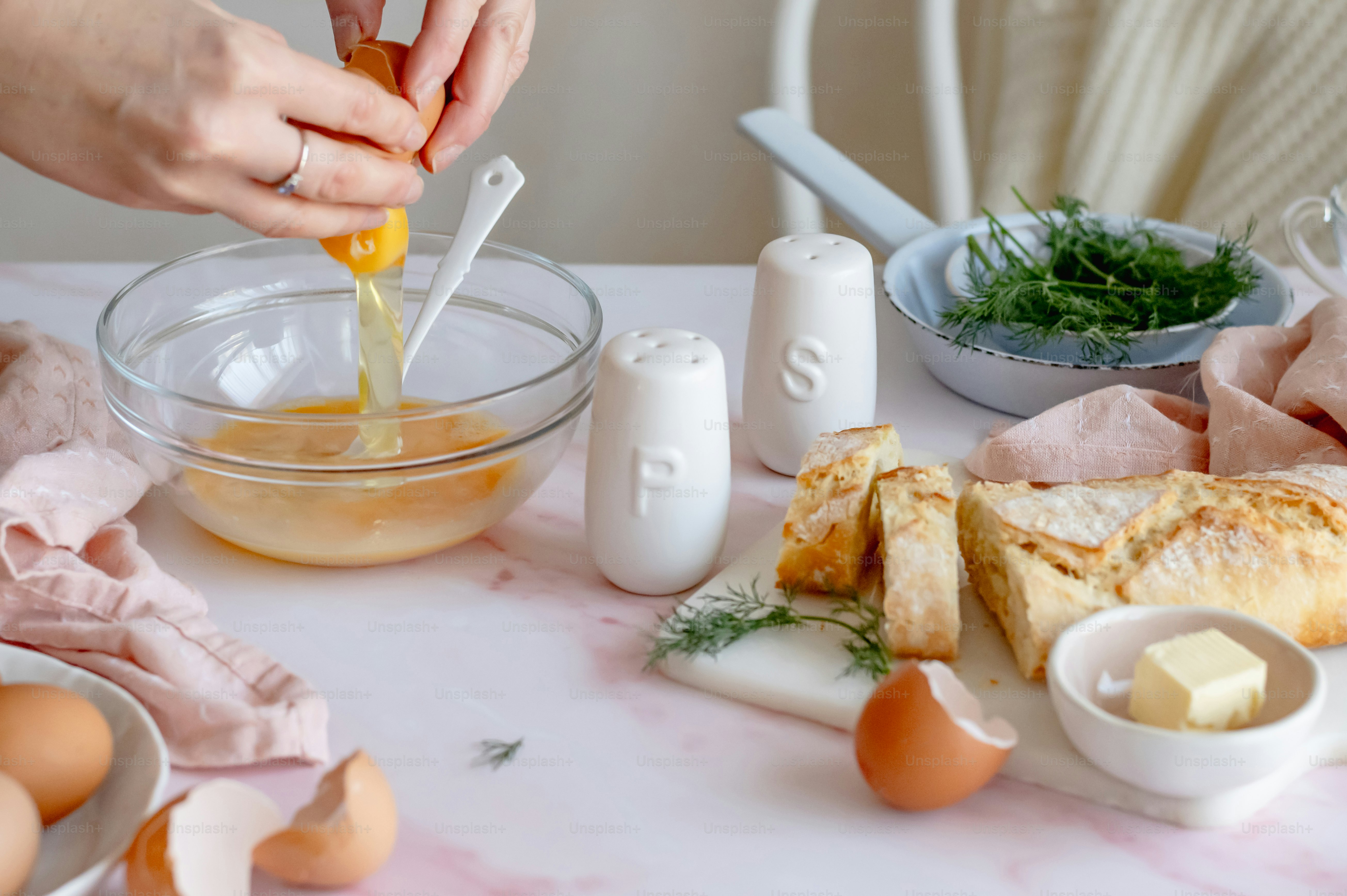a person is putting an egg in a bowl