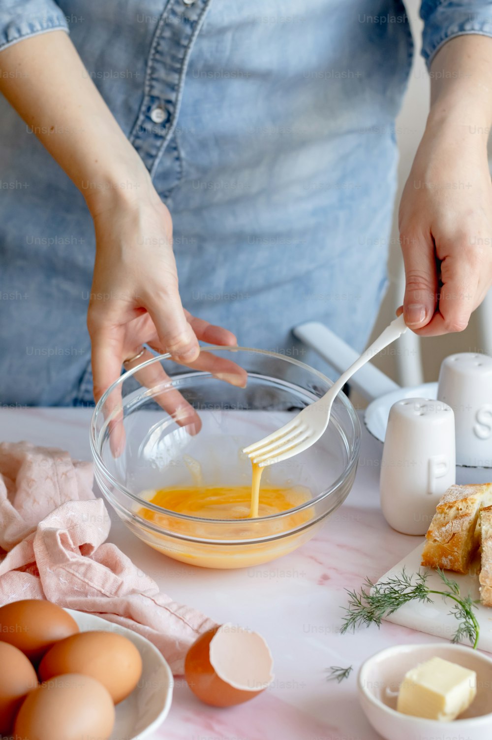 a woman is mixing eggs in a bowl
