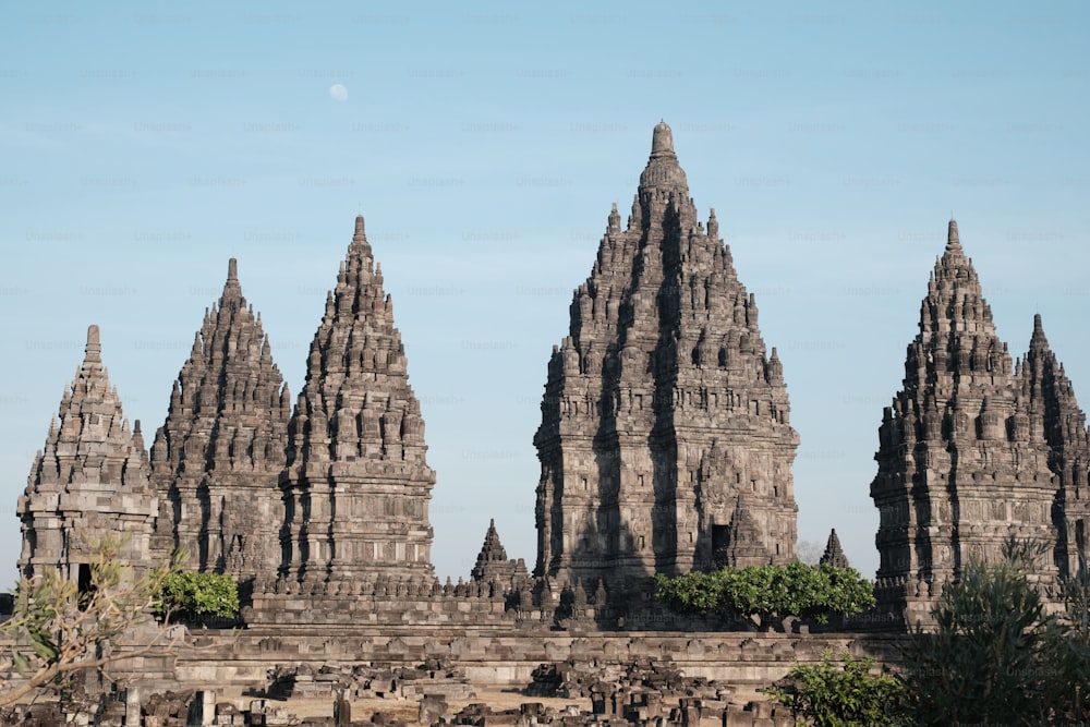 a large group of stone structures with a full moon in the background