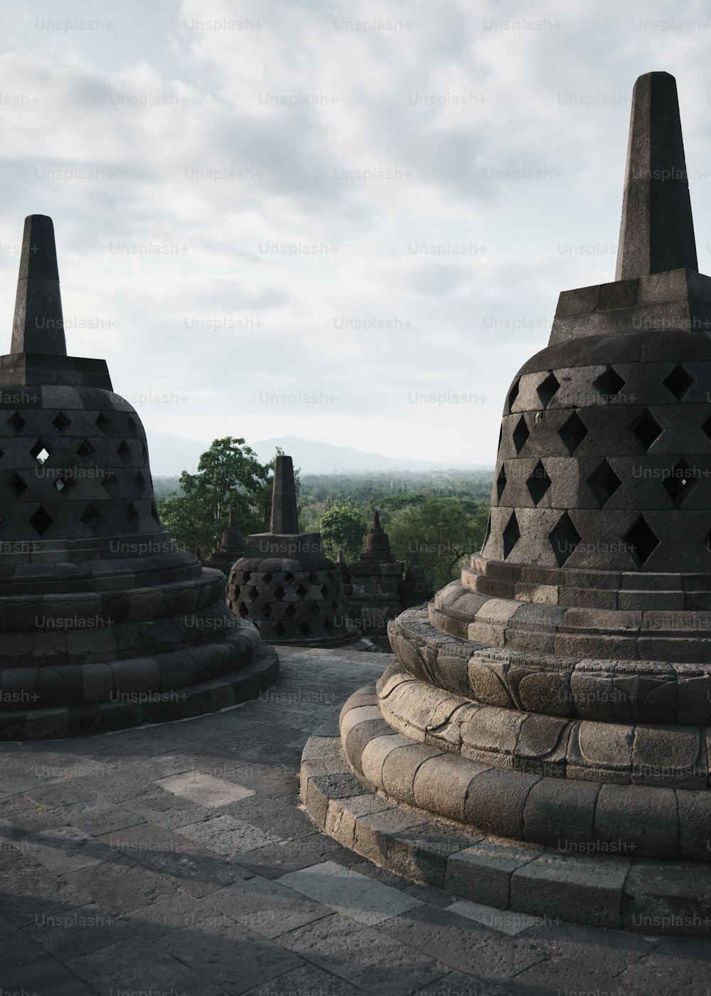 a group of stone structures sitting on top of a lush green field