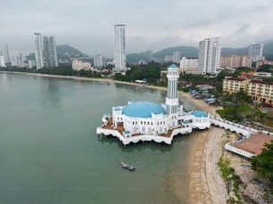 an aerial view of a white building with a blue dome