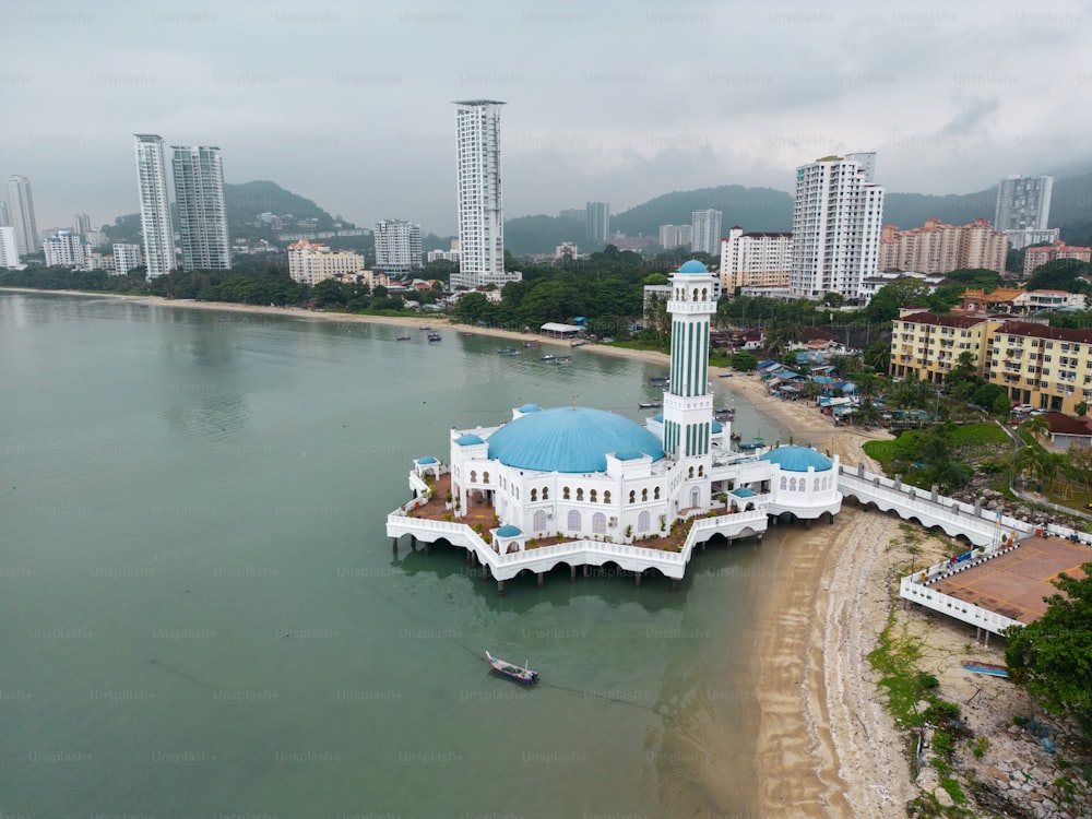 an aerial view of a white building with a blue dome