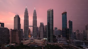 a view of a city at sunset with tall buildings