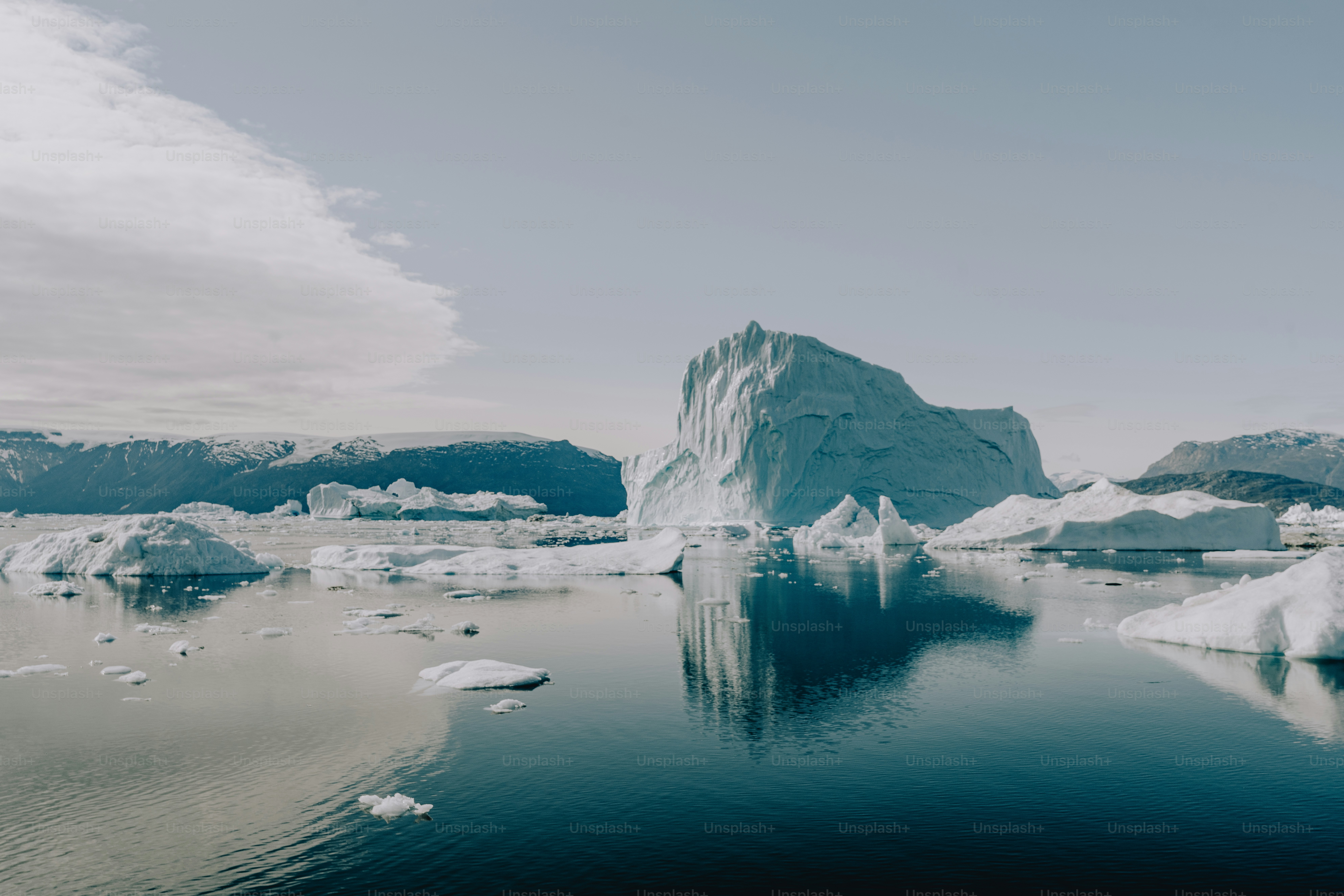 a large iceberg floating on top of a body of water