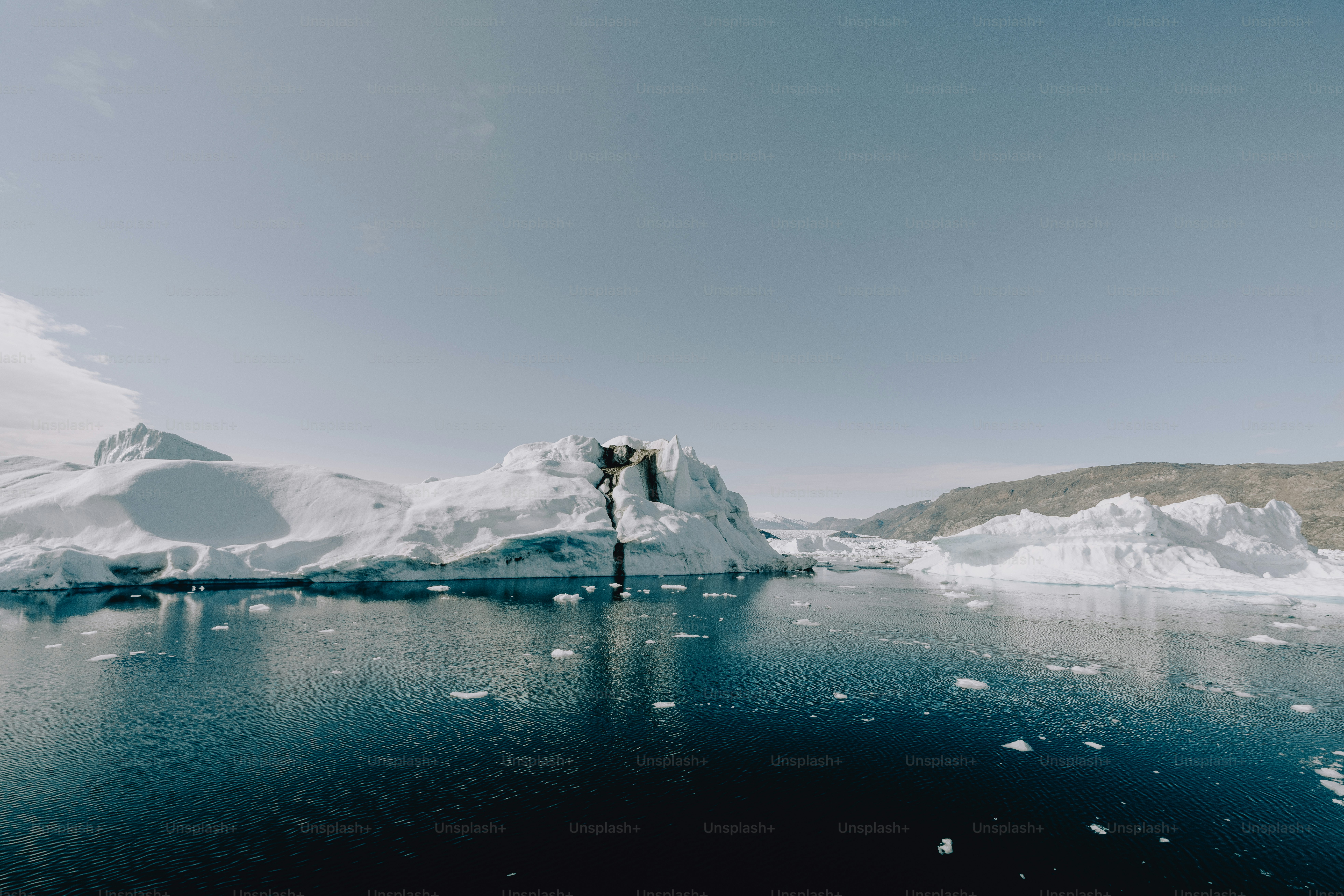 a large iceberg floating in the middle of a body of water