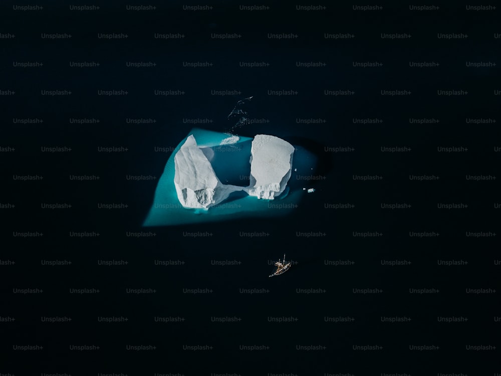 an aerial view of an iceberg in the water