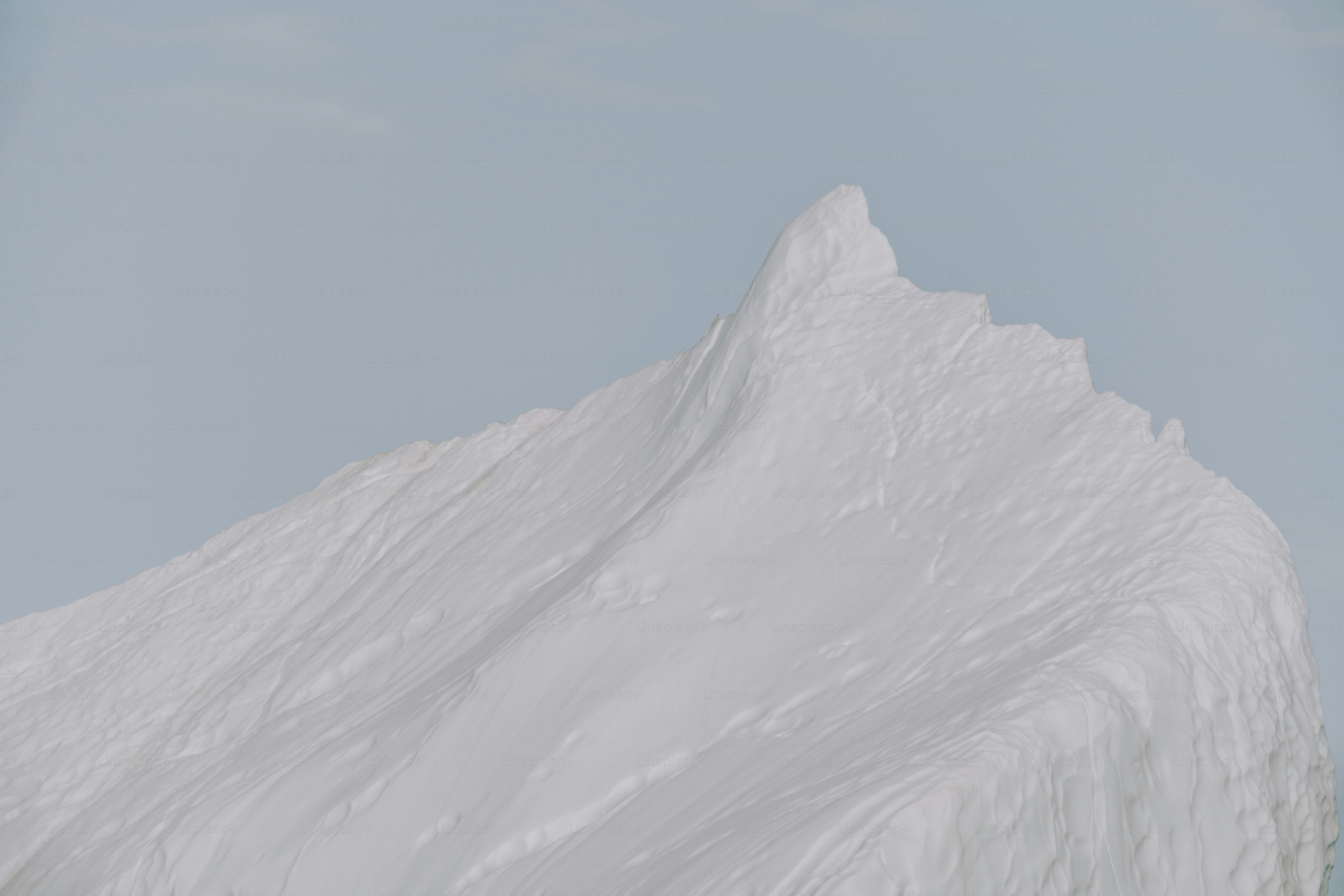 a person on a snowboard in front of a snow covered mountain