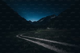 a dirt road in the middle of a mountain at night