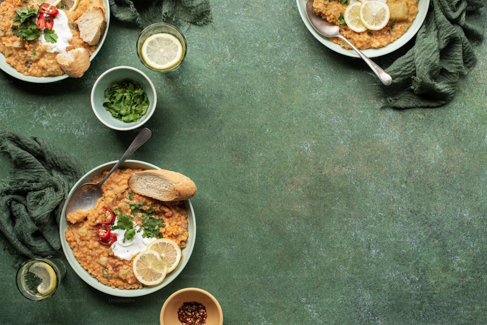 a table topped with plates of food and bowls of sauce