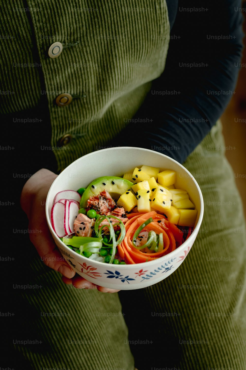 a person is holding a bowl of food