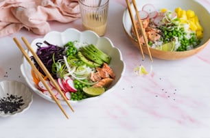 a table topped with bowls of food and chopsticks