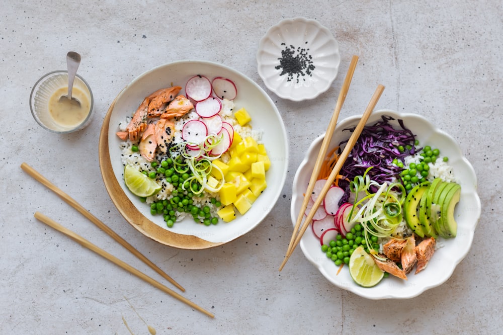 two bowls of food on a table with chopsticks