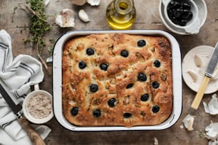 a casserole with olives in a baking dish