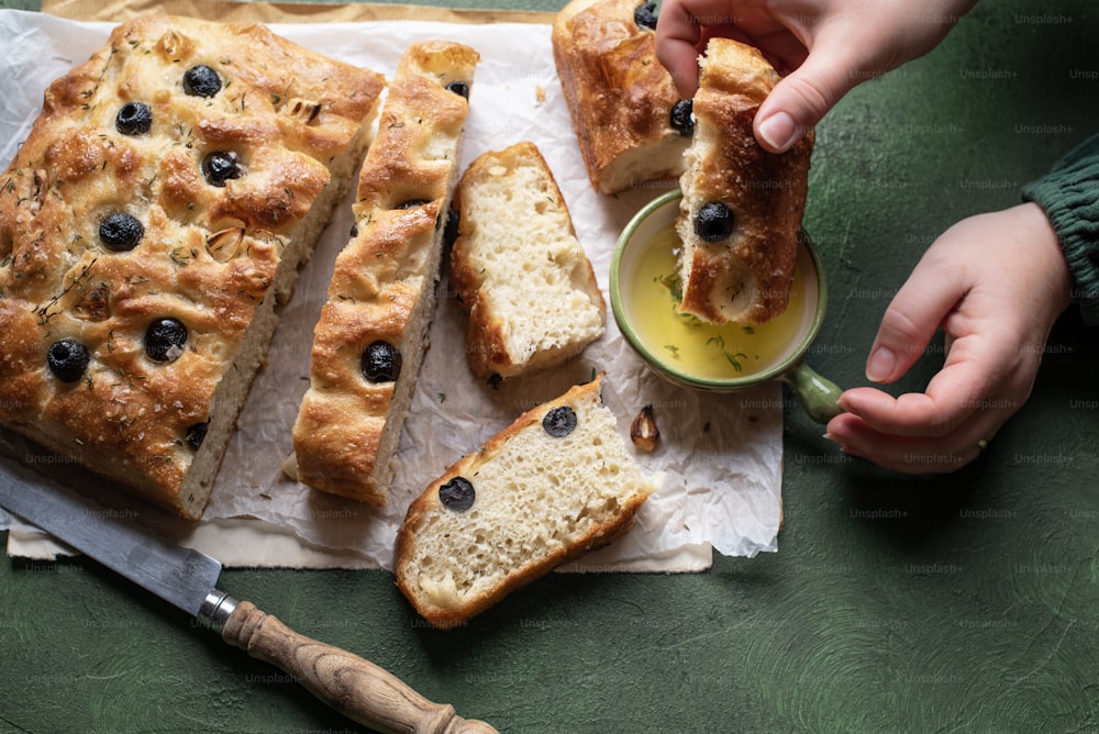 a person holding a piece of bread with blueberries on it