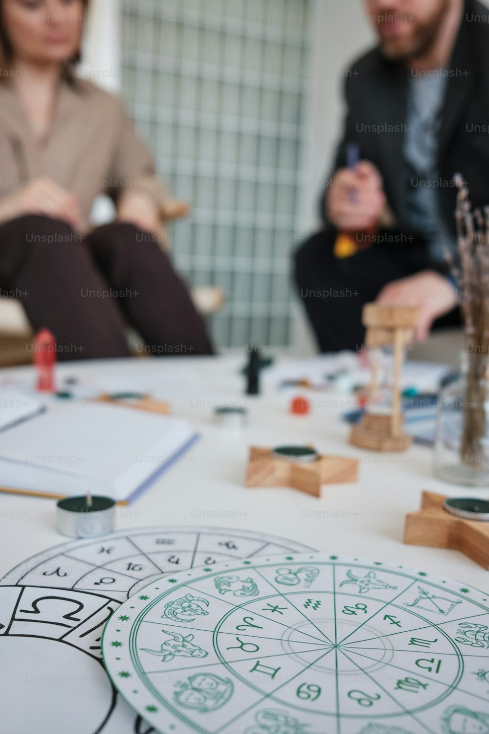 a couple of people sitting around a table with a clock on it