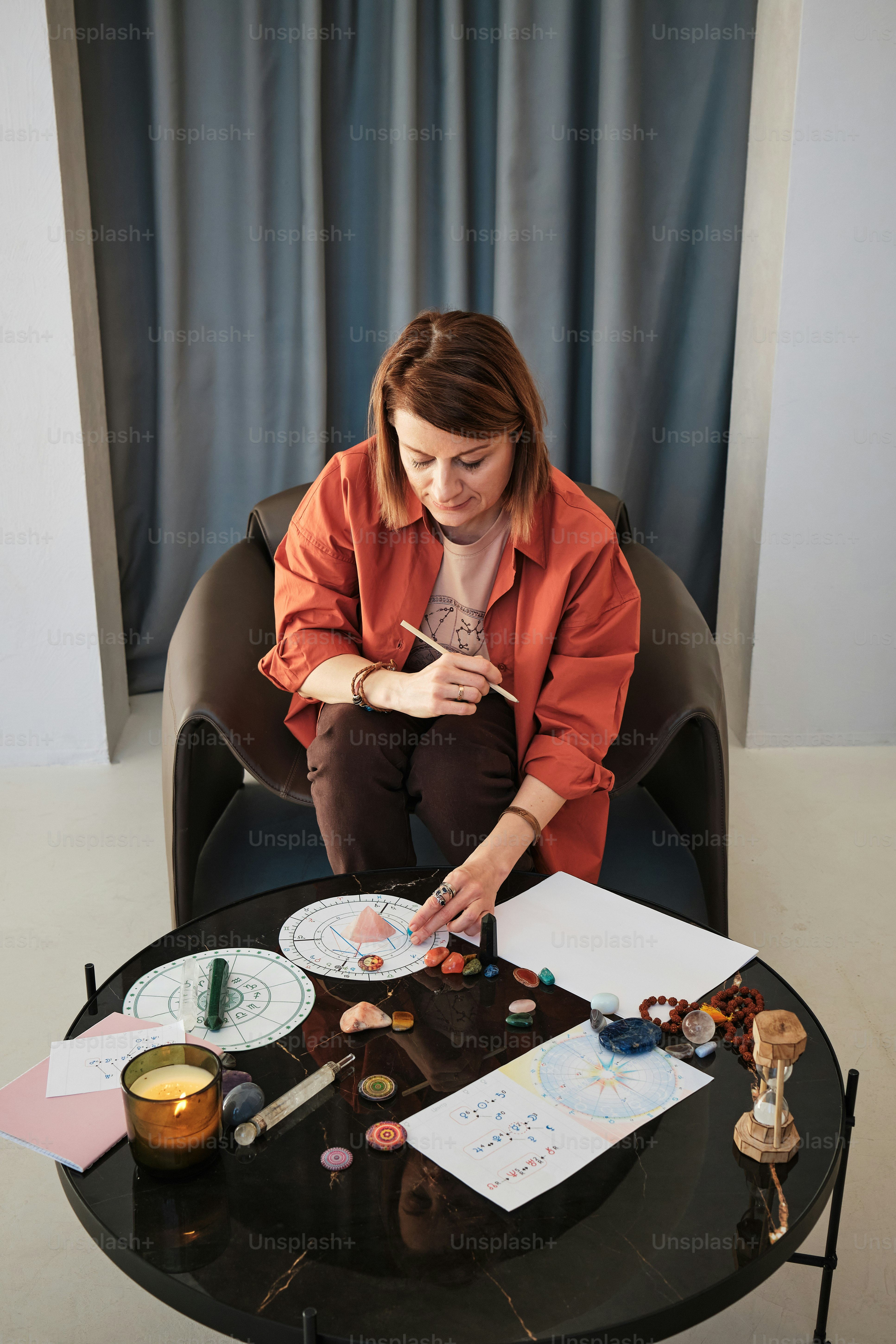 a woman sitting at a table with a cake on it