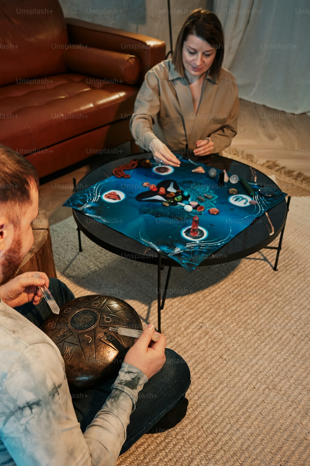 a man and a woman playing a game on a coffee table