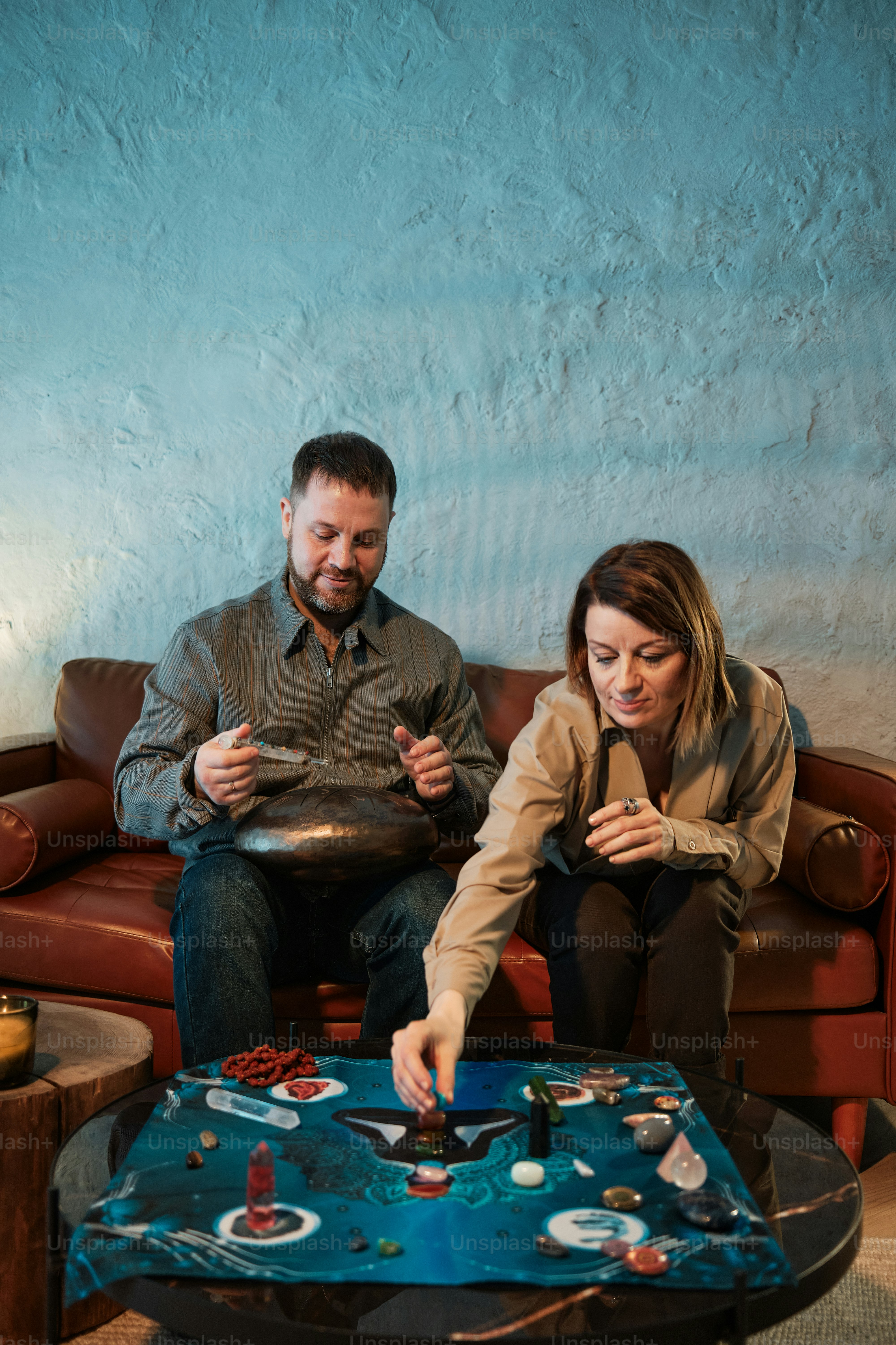 a man and a woman playing a game on a couch