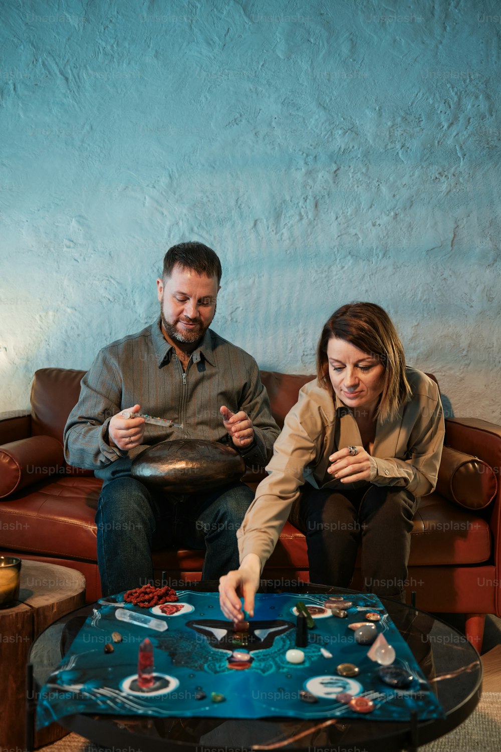 a man and a woman playing a game on a couch