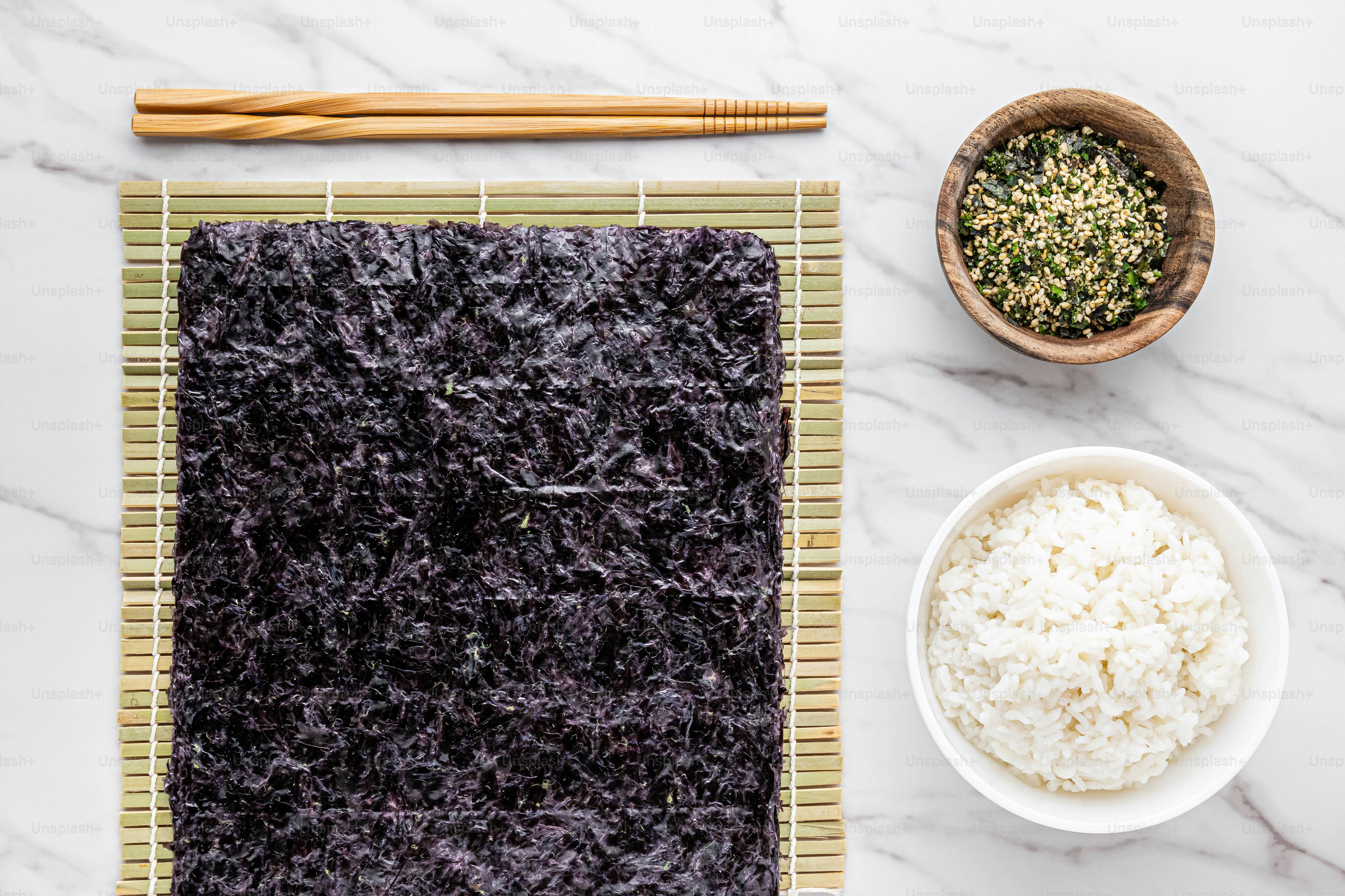 a bowl of rice next to a bowl of rice and chopsticks